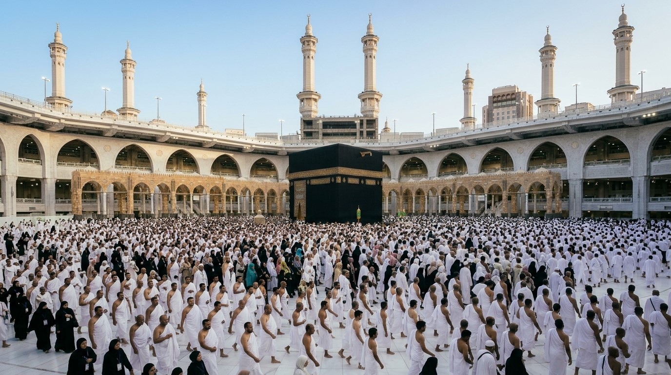 Muslim pilgrim in white Ihram touching the Yemeni Corner of the Kaaba during Tawaf in Makkah